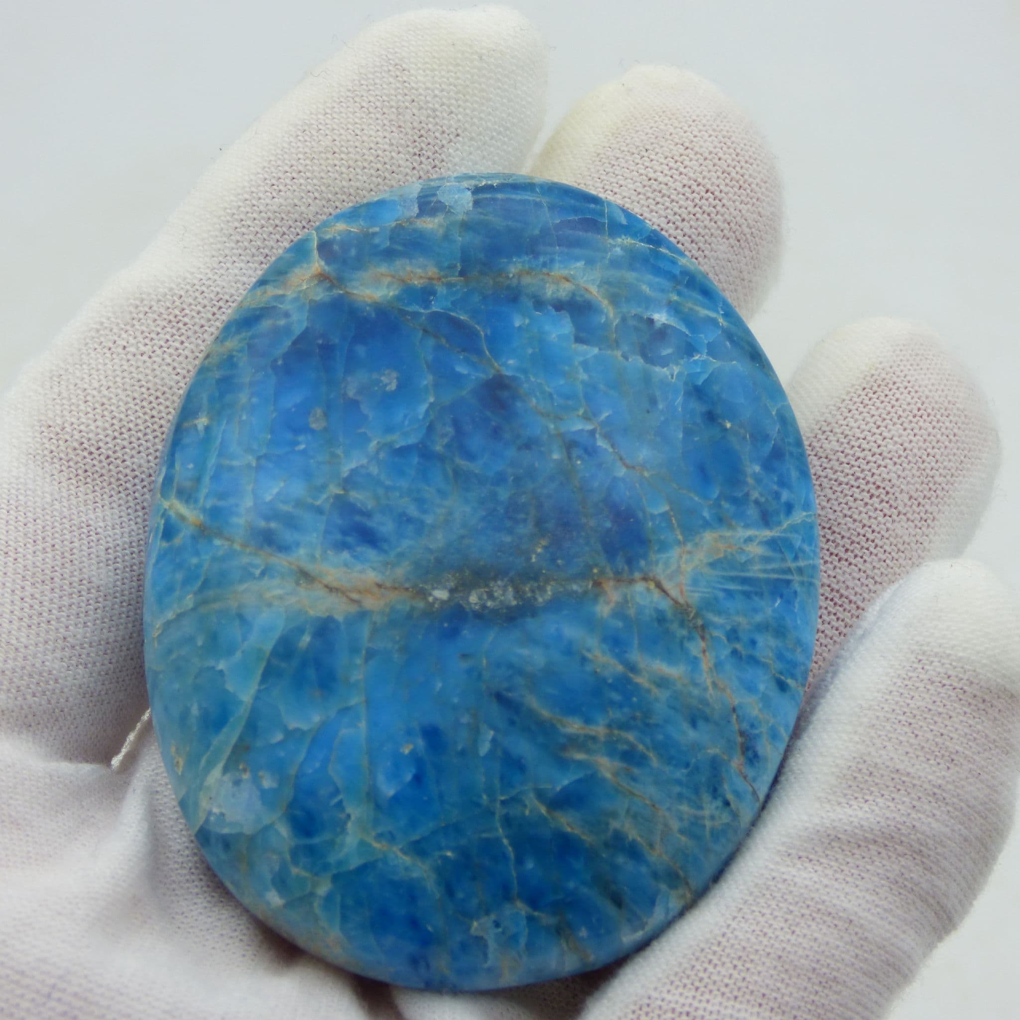 Blue apatite crystal palm stone in blue organza gift bag and with laminated card